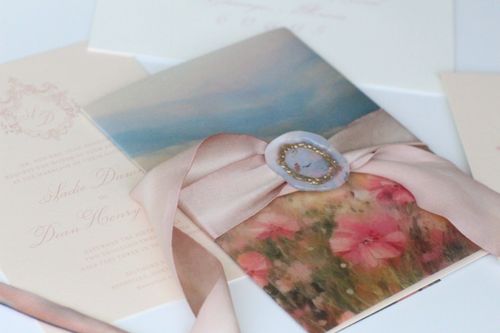 Blue and white invitation, blue envelope, and blue flower