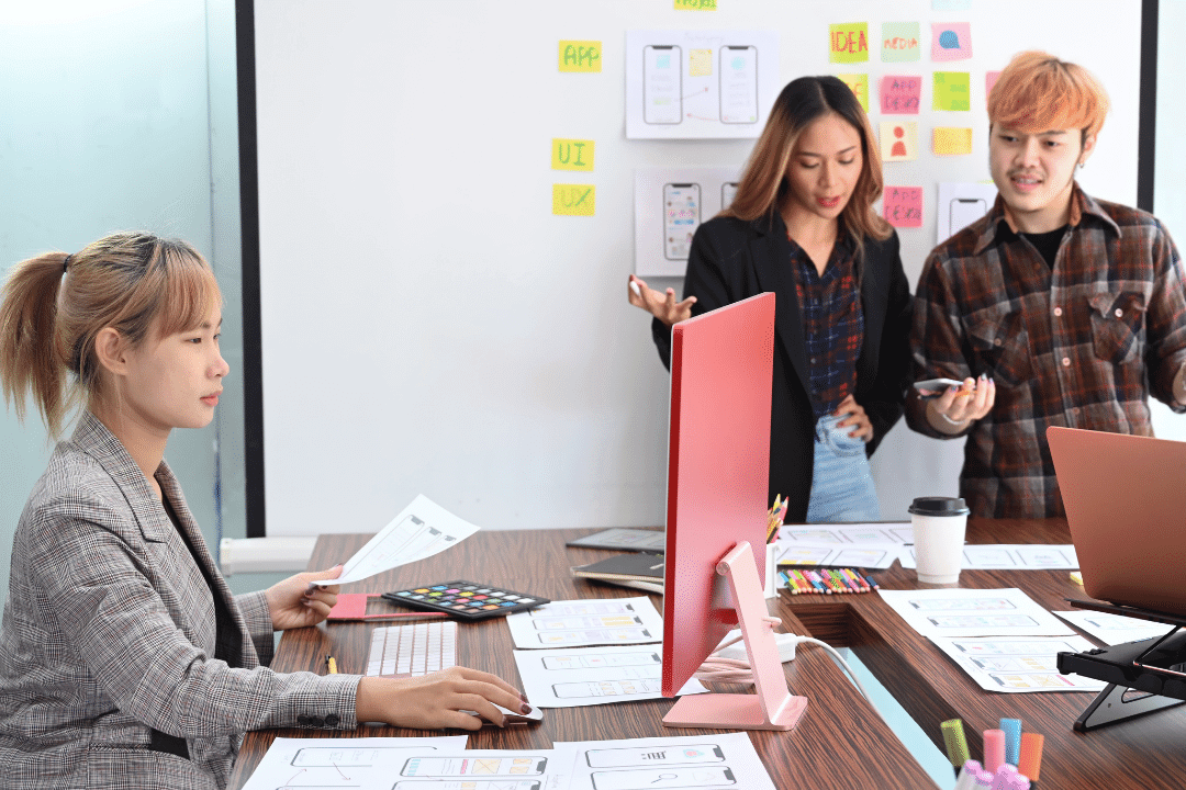 young user experience designers brainstorming in conference room