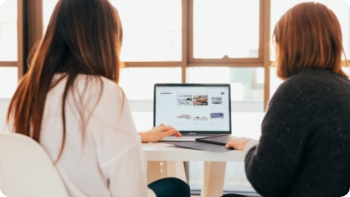 Two women looking at a laptop together