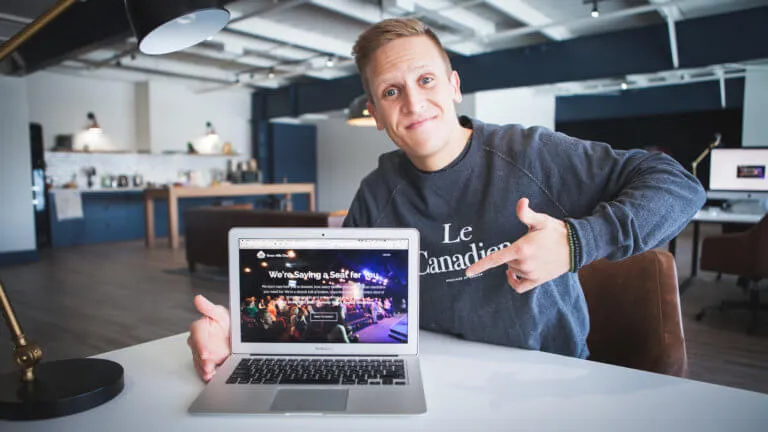 A man pointing at a laptop.