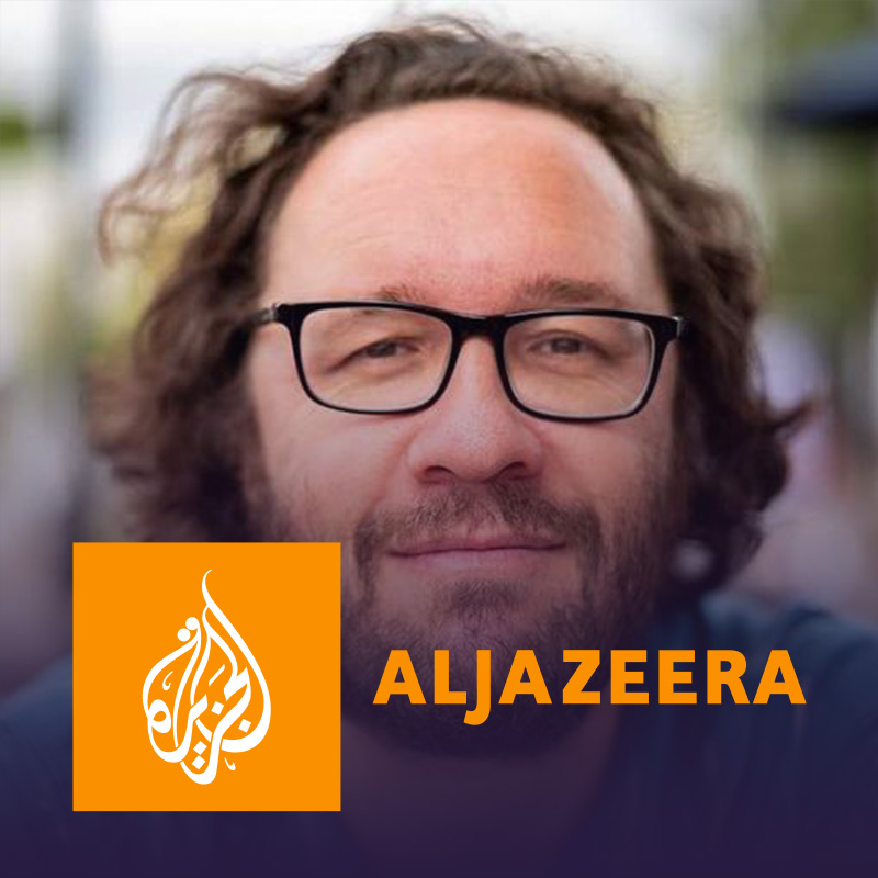 A photo of Evan Henshaw-Plath with the logo of the Al Jazeera network