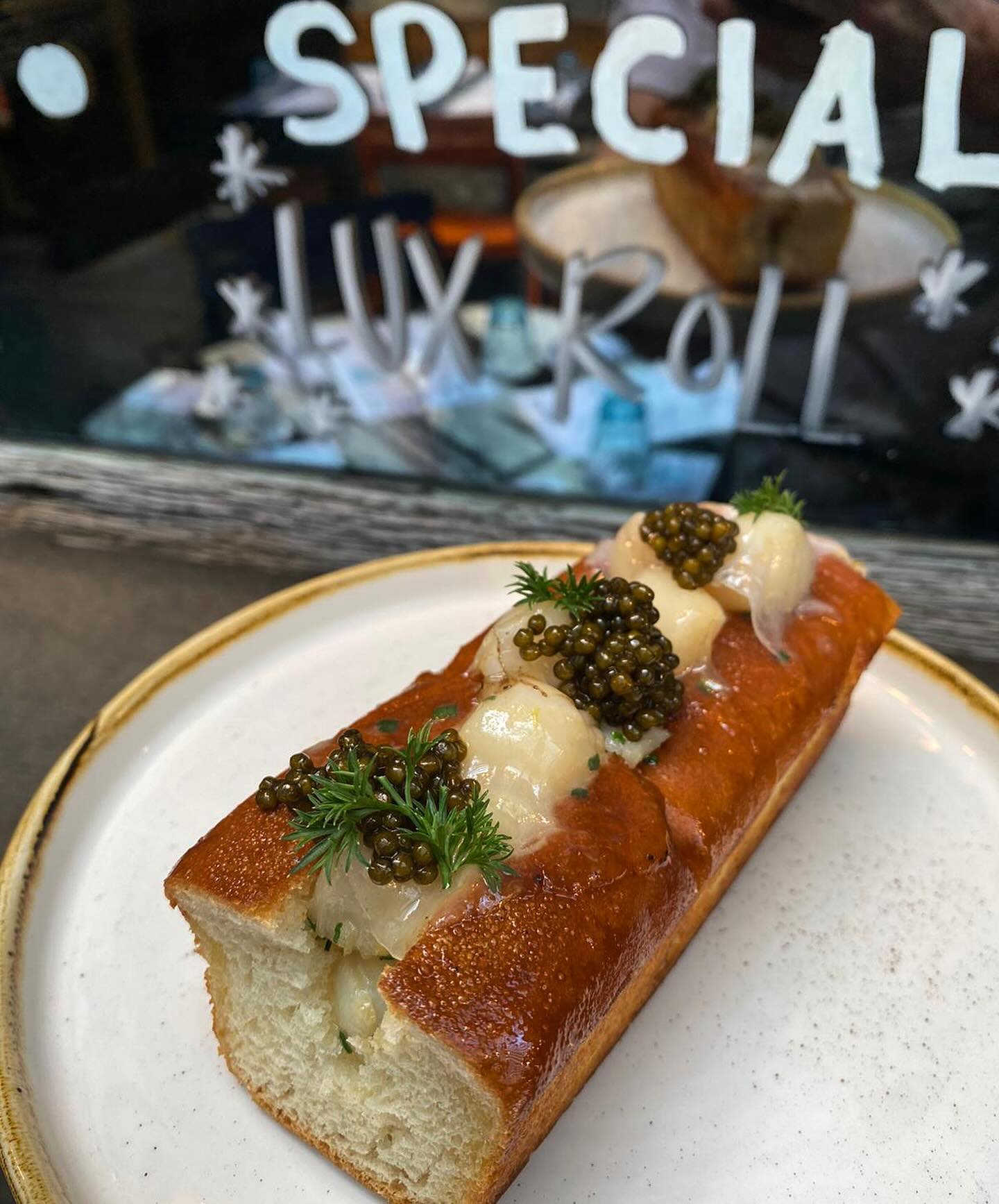 Lux Roll 🌟 with Bay Scallops sautéed in Amish maple butter, caviar, ibérico lardo, chive, + parsley