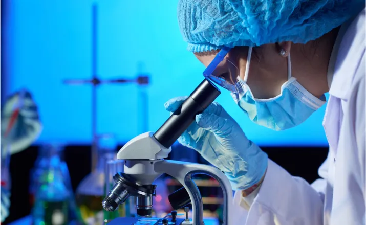 Bio scientist looking through a microscope